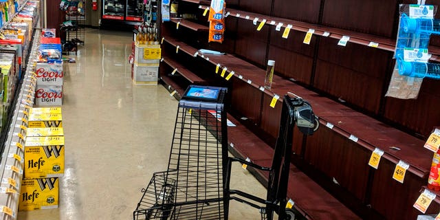 Supermarket shelves are stripped bare of bottled water in Salem, Ore., late Tuesday May 29, 2018, after officials warned residents that tap water was unsafe for children and the elderly due to an algae bloom.