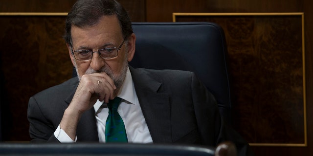 Spain's Prime Minister and Popular Party leader Mariano Rajoy listens to speeches during the first day of a motion of no confidence session at the Spanish parliament in Madrid.