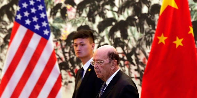 U.S. Commerce Secretary Ross, foreground, is in Beijing for trade talks after Washington ratcheted up tensions with a new threat of tariff hikes on Chinese high-tech exports.