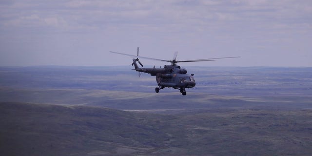 A Russian search and rescue team helicopter flies from the Kazakh town of Karaganda to Dzhezkazgan, on the eve of Russian Soyuz MS space capsule landing, Kazakhstan, Kazakhstan, Sunday, June 3, 2018.