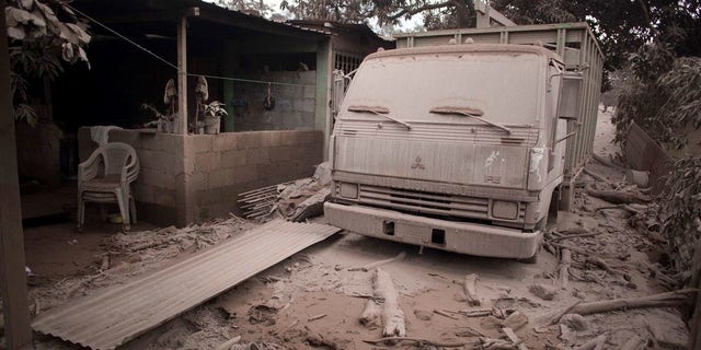 A truck is covered in volcanic ash spewed by Volcan de Fuego, or Volcano of Fire, in Escuintla, Guatemala, Monday.