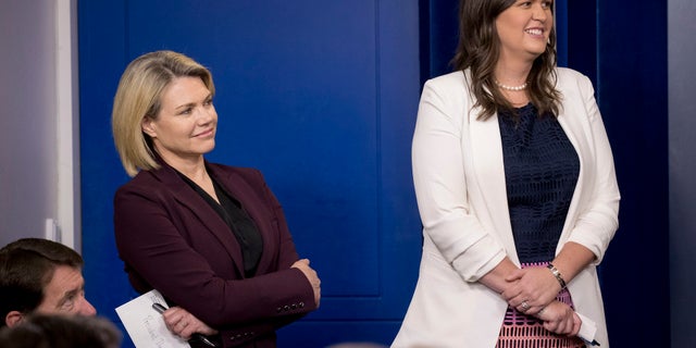White House press secretary Sarah Sanders, right, is in Singapore with the U.S. delegation.