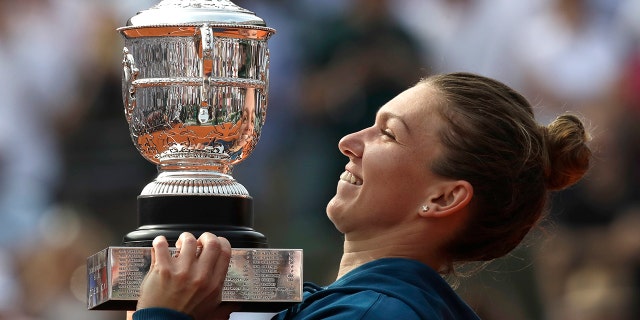 Romania's Simona Halep holds the cup after defeating Sloane Stephens of the U.S. during their final match of the French Open tennis tournament at the Roland Garros stadium.