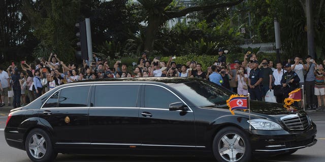 Kim Jong Un in a pullet-proof limousine in Singapore.