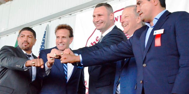 From left, International Boxing Hall of Fame Class of 2018 inductees Ronald Wright, Steve Albert, Vitali Klitschko, Jim Gray, and Erik Morales present their Hall of Fame rings to the crowd gathered in Canastota, New York on Sunday, June 10
