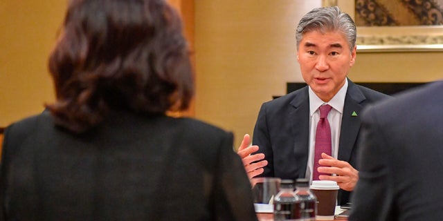 U.S. Ambassador Sung Kim talks with members of the North Korean delegation during a working group meeting in Singapore ahead of President Trump's meeting with North Korean leader Kim Jong Un.
