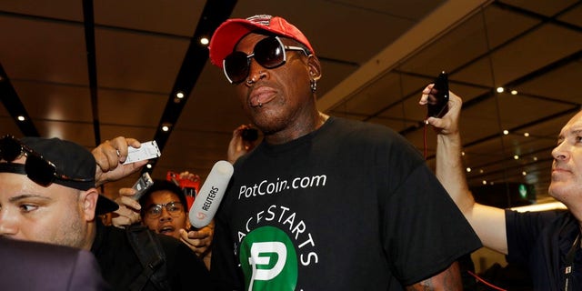 Former NBA basketball player Dennis Rodman arrives at Singapore's Changi Airport on Tuesday, June 12, 2018. (AP Photo/Wong Maye-E)