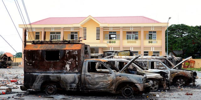 A row of charred vehicles is seen at the fire and police station in the south central province of Binh Thuan, Vietnam on Tuesday after protests on Sunday and Monday