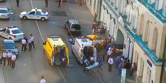 Ambulance and police work at the site of an incident after a taxi crashed into pedestrians on a sidewalk near Red Square in Moscow