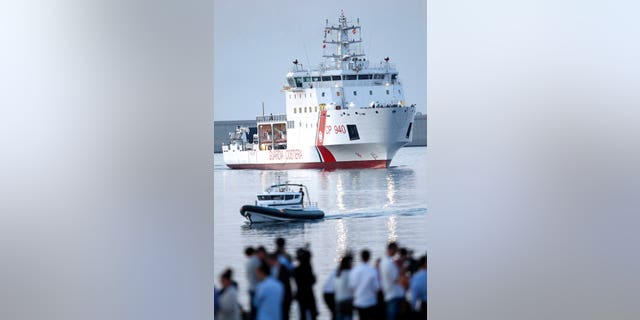 The Italian coast guard vessel Dattilo carrying migrants approaches the eastern port of Valencia, Spain, Sunday, Jun. 17, 2018.