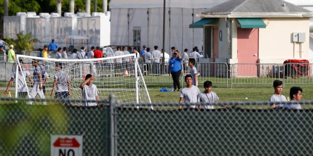 Immigrant children play outside a former Job Corps site that now houses them in Homestead, Fla. It is not known if the children crossed the border as unaccompanied minors or were separated from family members.