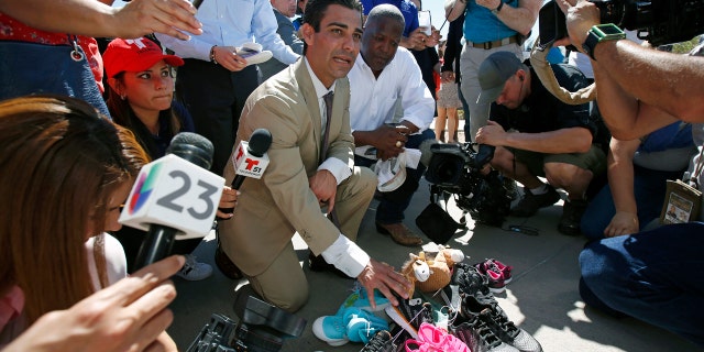Miami Mayor Francis Suarez, left, and Columbia, South Carolina Mayor Steve Benjamin explain to the media the symbolic gesture of bringing shoes as gifts for immigrant children that are being held at a facility in Tornillo, Texas, near the Mexican border, Thursday, June 21, 2018.