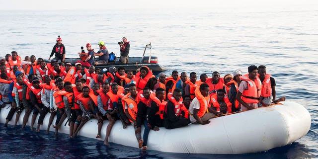 Migrants on a rubber boat are being rescued by the ship operated by the German NGO Mission Lifeline in the Mediterranean Sea in front of the Libyan coast