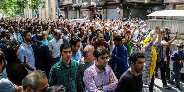 Iran has been beset by economic protests in recent days; a group of protesters chant slogans at the old grand bazaar in Tehran on Monday