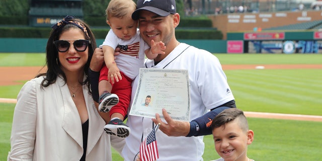 Detroit Tigers shortstop Jose Iglesias poses with his wife Arlene and their children Alvaro, 9 months and Jose, 7, after becoming an American citizen during a naturalization ceremony before a baseball game, in Detroit.