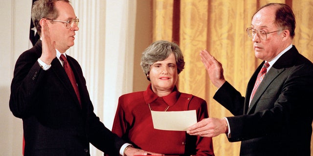 In this Feb. 18, 1988, photo Anthony Kennedy, left, takes the constitutional oath as a Supreme Court Associate Justice from Chief Justice William Rehnquist at a White House ceremony.