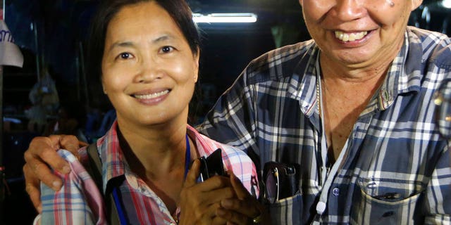 Family members smile after hearing the news that the missing 12 boys and their soccer coach have been found, in Mae Sai, Chiang Rai province