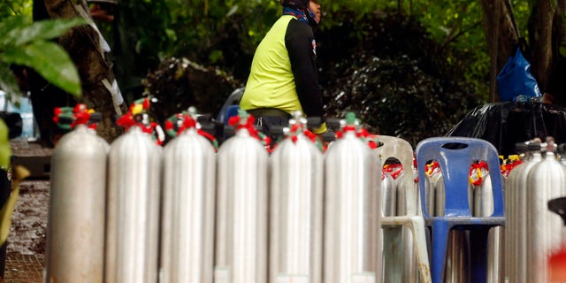 A Thai rescuer prepares oxygen tank for diving after the 12 boys and their soccer coach were found alive.
