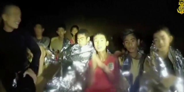 In this July 3, 2018, image taken from video provided by the Thai Navy Seal, Thai boys are with Navy SEALs inside the cave, Mae Sai, northern Thailand.