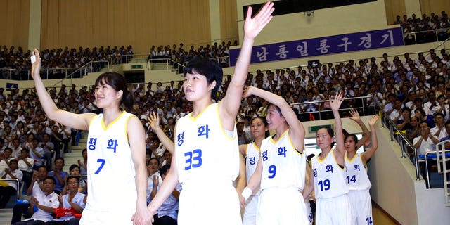 South and North Korean players of Team Peace wave as they arrive to play in a friendly basketball game at Ryugyong Jong Ju Yong Gymnasium in Pyongyang, North Korea, Wednesday, July 4, 2018.