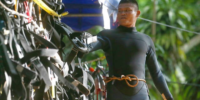 A Thai rescuer hangs his equipment outside a cave where 12 boys and their soccer coach are trapped, in Mae Sai, Chiang Rai province, in northern Thailand, Thursday