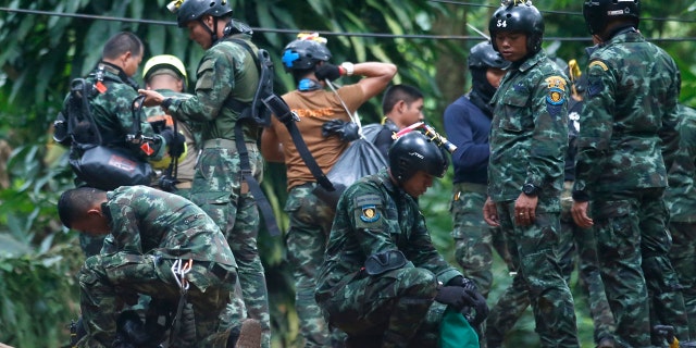 Thai rescuers prepare to enter the cave where 12 boys and their soccer coach have been trapped since June 23, in Mae Sai, Chiang Rai province, in northern Thailand Friday, July 6, 2018.