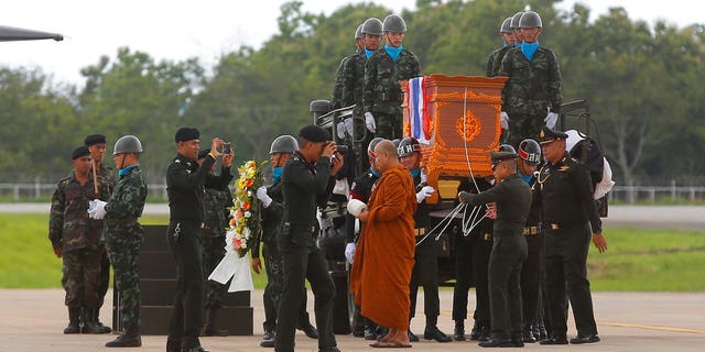 The body of Saman Gunan, a former Thai navy SEAL who died during an overnight mission, is carried during a repatriation and religious rites ceremony at Chiang Rai Airport in Mae Sai