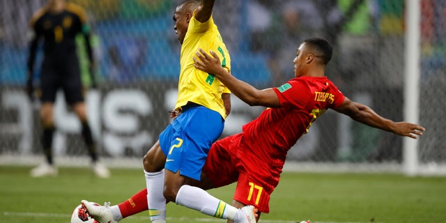 Brazil's Douglas Costa, left, is tackled by Belgium's Youri Tielemans during the quarterfinal match between Brazil and Belgium. Belgium won the match 2-1.