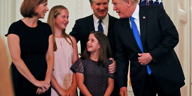 President Donald Trump talks with Judge Brett Kavanaugh his Supreme Court nominee, and his family in the East Room of the White House, Monday, July 9, 2018, in Washington.