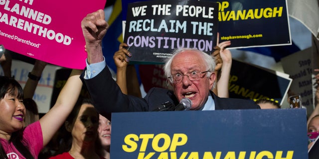 Sen. Bernie Sanders, I-Vt., speaks with protesters in front of the Supreme Court after President Trump announced Judge Brett Kavanaugh as his Supreme Court nominee.