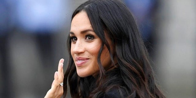 Meghan, Duchess of Sussex, waves as she visits Trinity college, in Dublin, Ireland, Wednesday, July 11, 2018. (Joe Giddens/PA via AP)