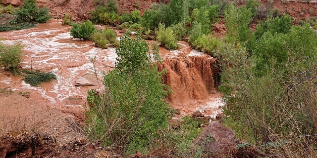 Flooding from a waterfall on the Havasupai reservation in Supai, Ariz., forced about 200 tourists to evacuated from a campground on tribal land near famous waterfalls deep in a gorge off the Grand Canyon, Thursday, July 12, 2018.