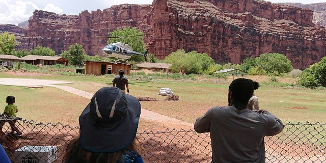 A helicopter lands to rescue people from flooding on the Havasupai reservation in Supai, Ariz., Thursday, July 12, 2018.