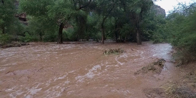 Torrents of water wash over a campground in Supai, Ariz., July 11, 2018.