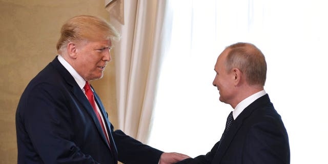 Then-President Donald Trump and Russian President Vladimir Putin, right, welcome each other at the Presidential Palace in Helsinki, Finland, Monday, July 16, 2018. 