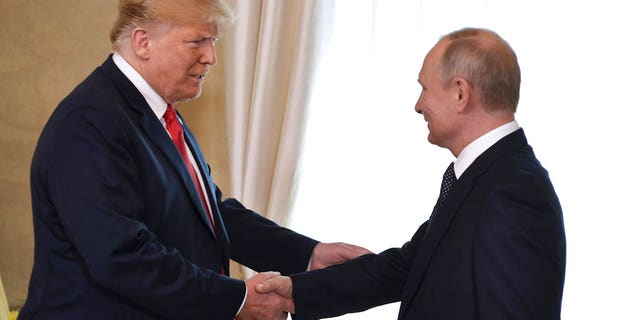 Then-President Donald Trump and Russian President Vladimir Putin, right, welcome each other at the Presidential Palace in Helsinki, Finland, Monday, July 16, 2018. 