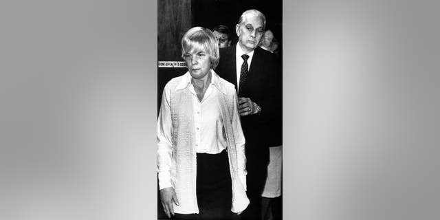 In this Feb. 1986 file photo, Marybeth Tinning is led from Schenectady County Court by Sheriff Bernard Waldron in Schenectady, N.Y.