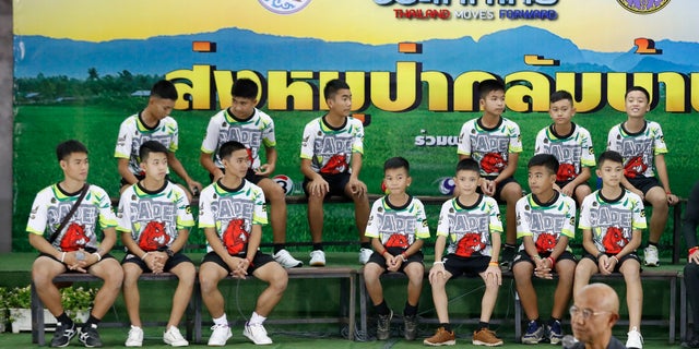 Members of the rescued soccer team and their coach sit during a press conference discussing their ordeal in the cave in Chiang Rai, northern Thailand.