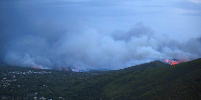 Smoke and fire coming from the town of Mati, east of Athens, Monday, July 23, 2018.
