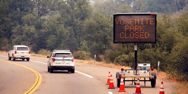 A sign on Highway 41 announces the closure of Yosemite National Park near Oakhurst, Calif., on Wednesday, July 25, 2018. Parts of the park closed Wednesday as firefighters work to contain the Ferguson fire burning nearby.