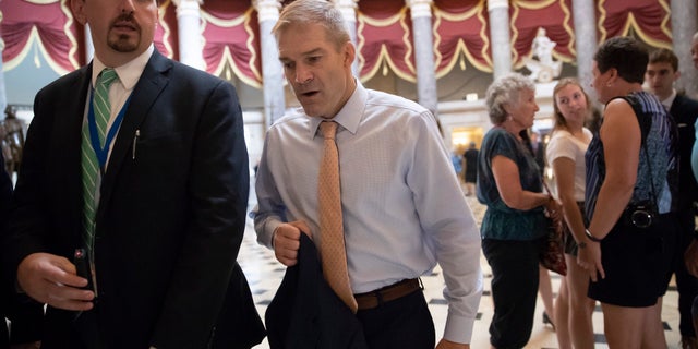 Rep. Jim Jordan, R-Ohio, walks to the House chamber as he prepares to file articles of impeachment against Deputy Attorney General Rod Rosenstein.