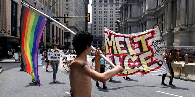 Protesters camped outside City Hall march in the street after a decision about ICE was made, Friday July 27, 2018, in Philadelphia. Mayor Jim Kenney announced Friday that Philadelphia will stop giving U.S. Immigration and Customs Enforcement (ICE) access to a real-time arrest database.