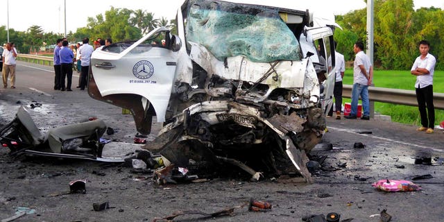 A van is damaged after colliding with a container truck on Monday.