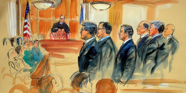 This courtroom sketch depicts Paul Manafort, fourth from right, standing with his lawyers in front of U.S. district Judge T.S. Ellis III, center rear, and the selected jury, seated left.
