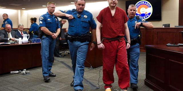 In this Aug. 26, 2015, file photo, Colorado theater shooter James Holmes, right, is led out of the courtroom after being formally sentenced in Centennial, Colo., to serve life in prison without parole.
