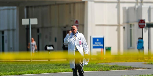 A physician walks out of the emergency entrance to Westchester Medical Center, Wednesday, Aug. 8, 2018, in Valhalla, N.Y.