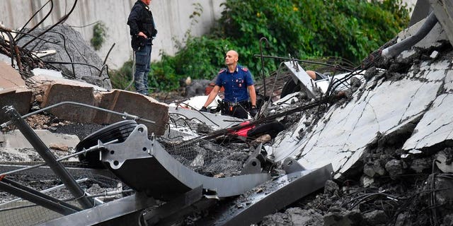 Rescues work among the debris of the collapsed Morandi highway bridge in Genoa.