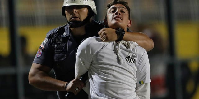 Police clash with soccer fans protesting 3-0 score imposed before match, game abandoned.
