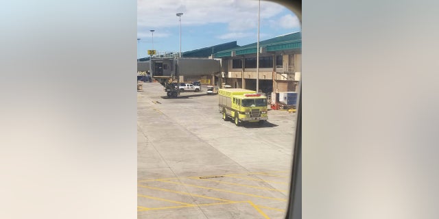 A fire truck is seen outside a Hawaiian Airlines jet in Kahului, Hawaii, after a can of pepper spray went off inside the plane during a flight from Oakland, Calif., Aug. 31, 2018.