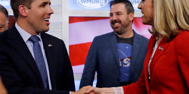 Chris Pappas (left) shakes hands with Maura Sullivan (right) following a debate for Democratic hopefuls in New Hampshire's 1st congressional district.